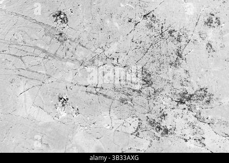 A detailed monochromatic image of crack patterns on a concrete surface, showcasing intricate texture and abstract forms. This artistic composition emp Stock Photo