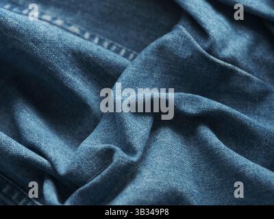 A background of blue wrinkled denim jeans. Close up. Stock Photo