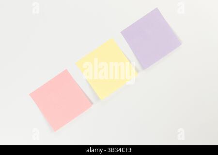 Top view of colorful sticky notes on white background. School, office wallpaper. Flat lay, copy space. Stock Photo