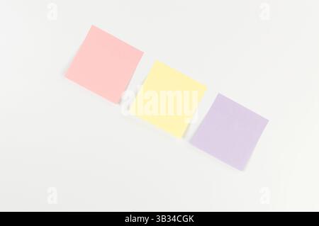 Top view of colorful sticky notes on white background. School, office wallpaper. Flat lay, copy space. Stock Photo