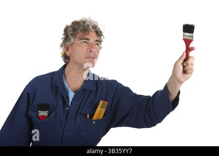 Handsome handyman in blue overall ready for the job Stock Photo