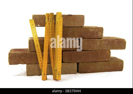 Bricks and measuring tool to build a wall or making pavement Stock Photo