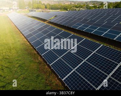 Rows of photovoltaic solar panels on agricultural land generating clean sustainable energy for business and domestic purposes Stock Photo