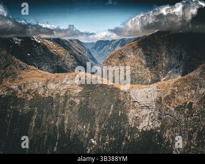 Aerial views by helicopter through Milford Sound fjords, over lake Quill and Sutherland Falls in Spring, South Island of Aotearoa New Zealand Stock Photo