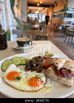 A traditional Turkish breakfast served with coffee on a wooden table in a quiet, calm cafe in London, England. Stock Photo
