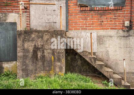 Grungy exterior wall on abandoned building with brick and cement Stock Photo