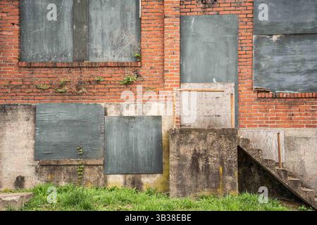 Grungy exterior wall on abandoned building with brick and cement Stock Photo