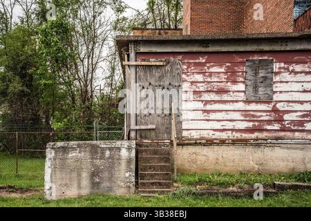Grungy exterior wall on abandoned building with brick and cement Stock Photo