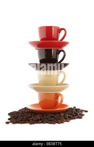 Stacked cups and saucers with coffee beans isolated over white background Stock Photo