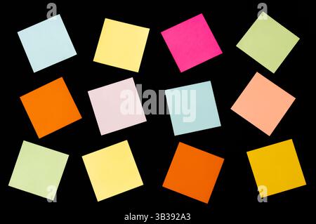 Colorful note papers, collection of different colored sheets on black background, text your message, reminder Stock Photo
