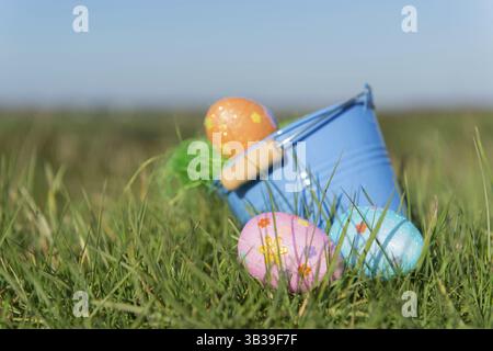Bucket with chocolate easter eggs outdoor in the garden Stock Photo