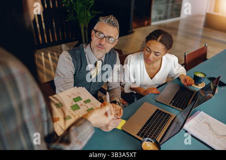 Engaging Business Meeting with Professionals Discussing Strategic Ideas and Plans Effectively Stock Photo
