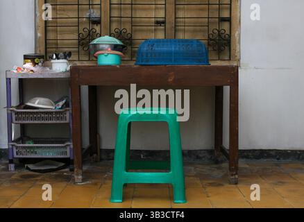 Indonesia, Sukoharjo - April 28, 2025: the condition of the room contains a simple home interior containing a table shelf full of glasses, wooden tabl Stock Photo