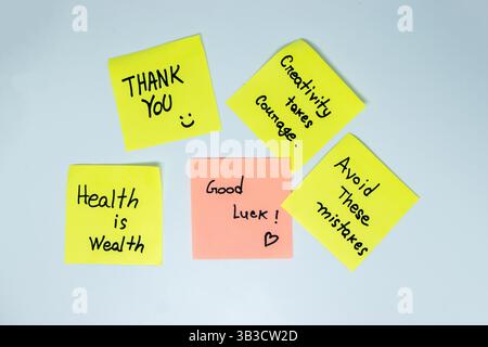 Positive affirmations concept. Phrases of different colors sheets for notes on a green background. Motivational concept with handwritten text. Stock Photo