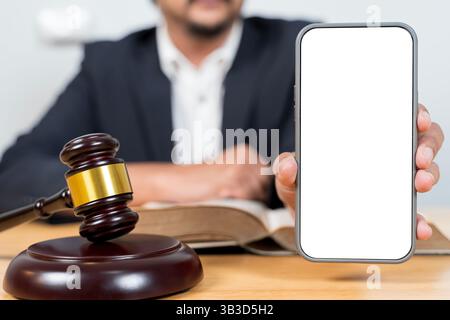 Cropped view of lawyer pointing with finger at smartphone with blank screen, and gavel on desk isolated on grey. Clipping path. Copy space. Template. Stock Photo