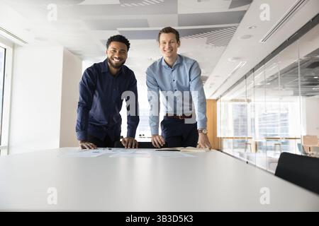 Portrait of two men business analysts standing in modern office Stock Photo