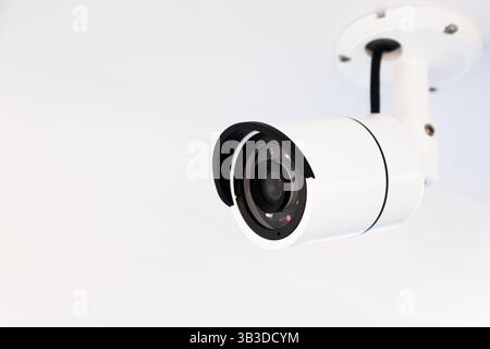 CCTV camera on the hull of an expensive motor yacht. CCTV camera white on a white body. Stock Photo