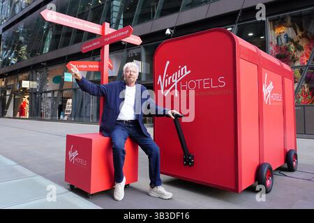 Sir richard branson with a giant virgin hotels branded red