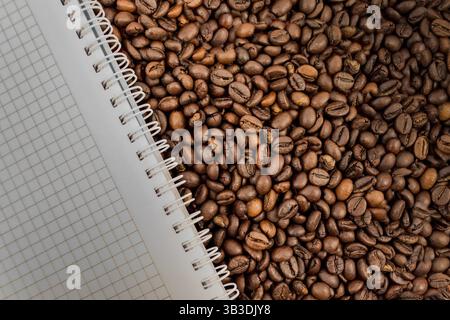 Full frame of coffee beans also with empty notebook Stock Photo