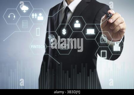 Businessman draw Fintech word on digital virtual screen . Hi-tech business concept Stock Photo