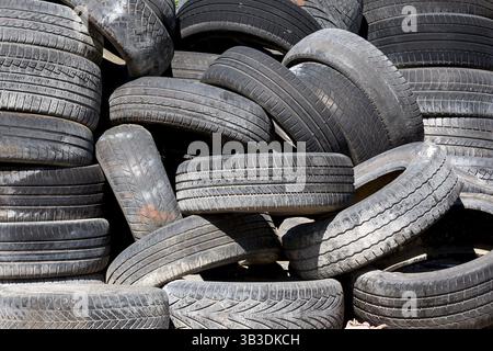 Old and used car tyres on a pile Stock Photo