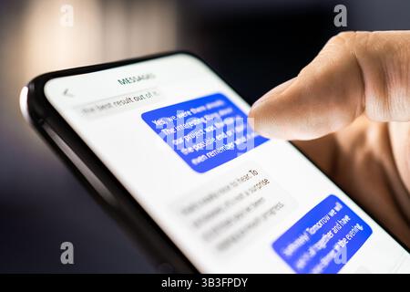 Text messages in phone. Texting mobile sms with friend on chat app. Business conversation. Scam or fraud with smartphone. Work discussion. Stock Photo