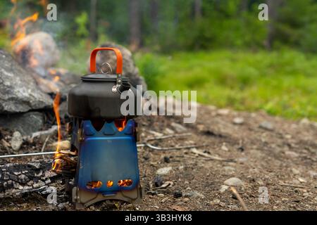 Cooking on an open fire at a campsite Stock Photo