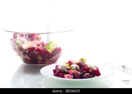 Fresh vegetable salad with mozzarella and boiled beetroot isolated on white background. Stock Photo