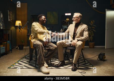 Two Men Greeting Each Other In Recording Studio Stock Photo