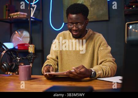 Man Reading Content Plan Before Podcast Stock Photo