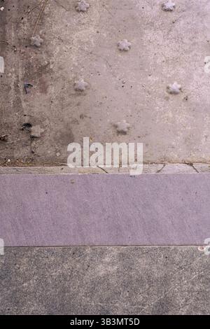 Worn concrete surface with decorative raised patterns Stock Photo