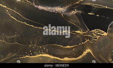 Beautiful abstract alcohol ink design featuring rich black and gold tones Stock Photo