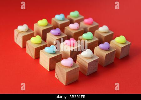 Colorful plastic hearts on wooden cubes Stock Photo