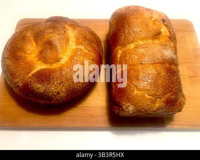 Top view of two traditional Bulgarian kozunak loaves, baked for Easter with a golden crust and braided shape, traditional Easter bread, holiday baking Stock Photo