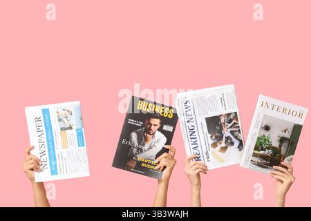 Female hands with different magazines and newspapers on pink background Stock Photo