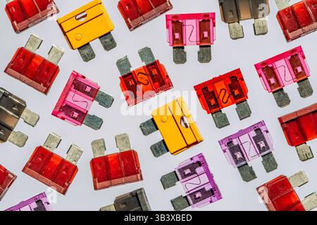 Close-up of a chaotic assortment of automotive fuses in various colors and ratings — ideal for illustrating car electronics, repairs, or spare parts Stock Photo