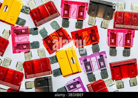 Close-up of a chaotic assortment of automotive fuses in various colors and ratings — ideal for illustrating car electronics, repairs, or spare parts Stock Photo