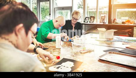 Autism, down syndrome and disability classroom art activity, learning skills development and physical therapy. Nurse, special needs creative teacher Stock Photo