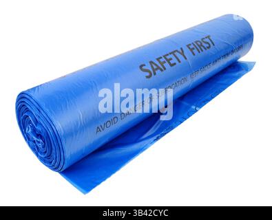 Roll of blue plastic bin bags with warning text printed on each bag isolated on a white background Stock Photo