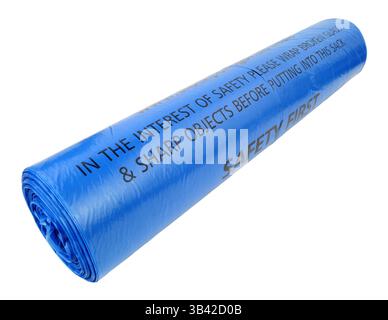 Roll of blue plastic bin bags with warning text printed on each bag isolated on a white background Stock Photo