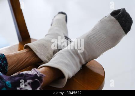 Old woman with worn socks Stock Photo