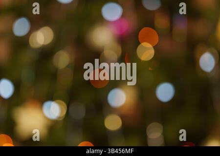 the blurred multicolored circles of light on a dark background, abstract play of light, beautiful light spots Stock Photo