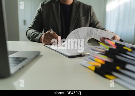 businesswoman signing document On Contract Paper reading and checking financial documents Stock Photo