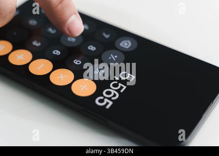 man accountant working on desk using calculator calculate while working analytic Accounting Stock Photo