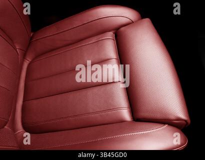Car red leather interior. Red leather car seat details with stitching. Interior of prestige car. Comfortable perforated leather seats. Stock Photo