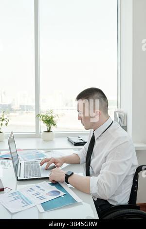 Young businessman using laptop during work with data Stock Photo