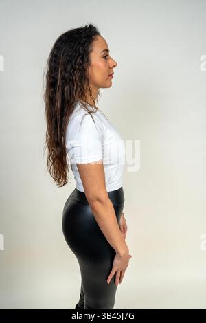 Fitness model showcasing comfortable and stylish activewear in a studio setting Stock Photo