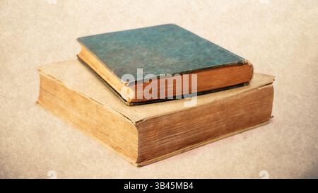 old books isolated on white background. Old damaged books stacked on top of each other. Stock Photo