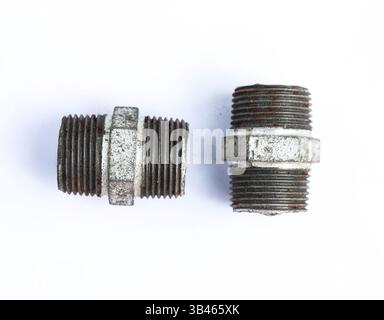 Two old, threaded metal pipe nipples with visible rust. Showing wear and tear with corroded surfaces on a bright white background. Stock Photo