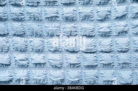Soft blue fabric with textured stripes creates a cozy and inviting atmosphere in a home setting Stock Photo